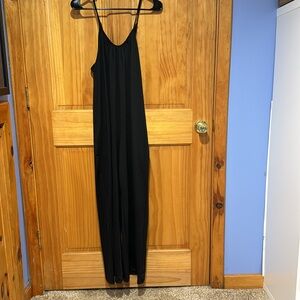 Black romper with spaghetti straps has pockets